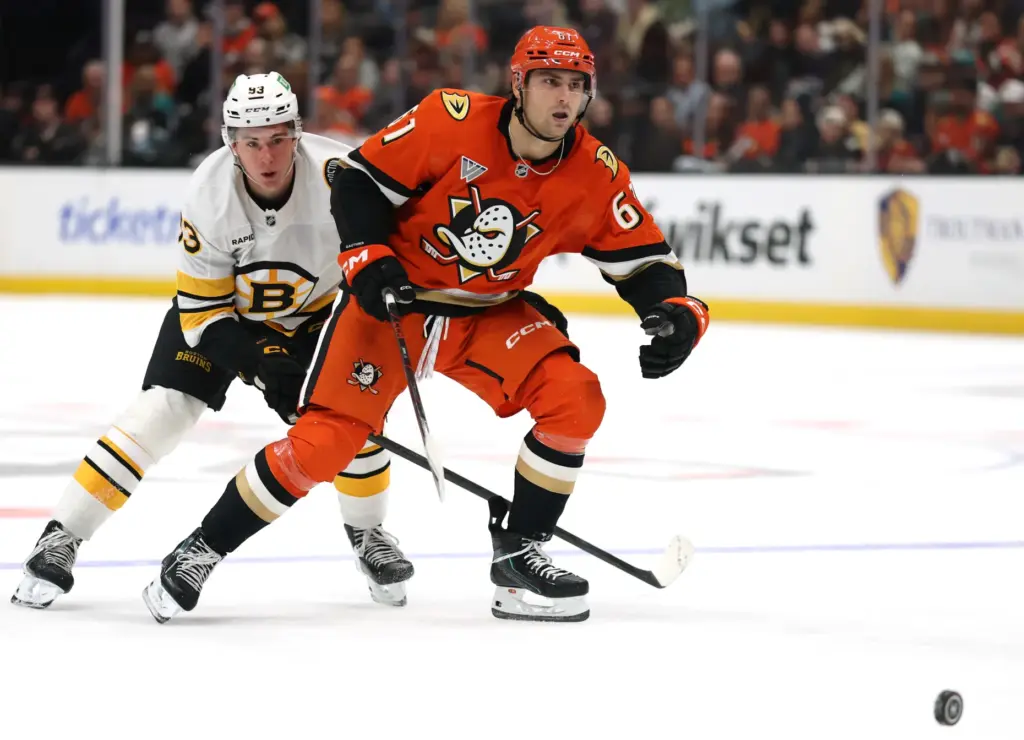 The Ducks’ Cutter Gauthier, right, is forechecked by the Boston...