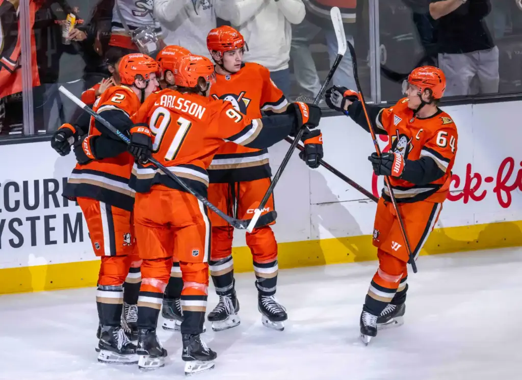 Ducks players celebrate a first-period goal by Cutter Gauthier (61)...