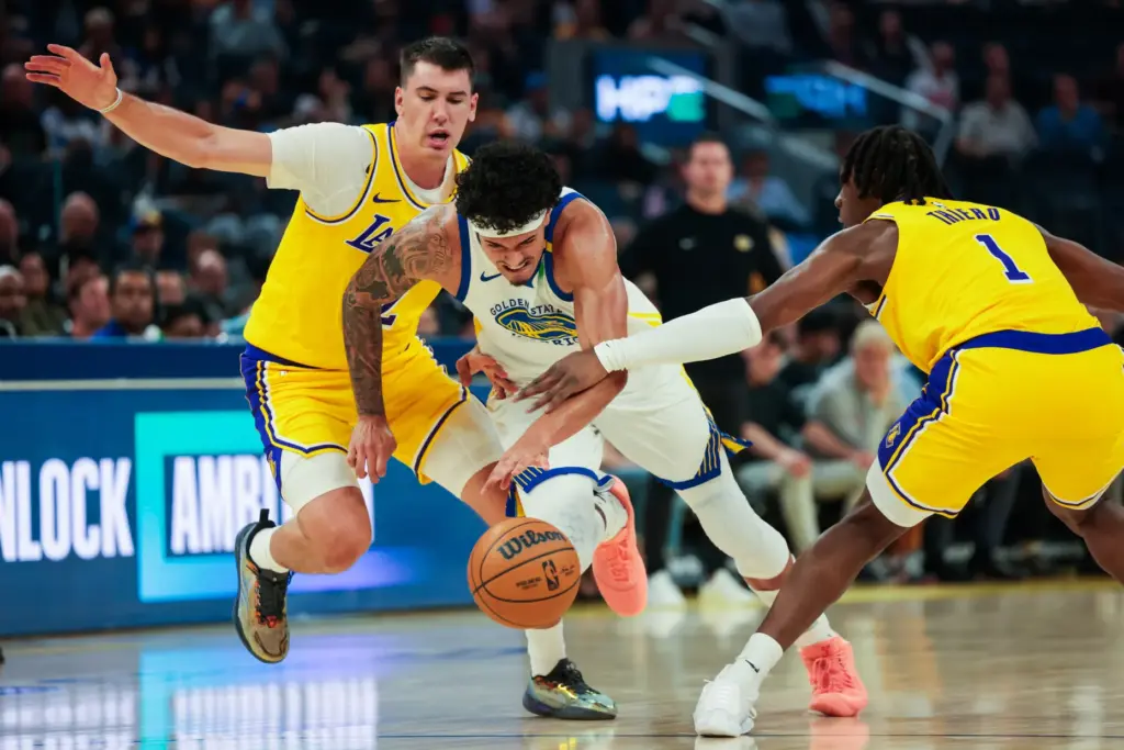 Golden State Warriors forward Gui Santos tries to drive between...