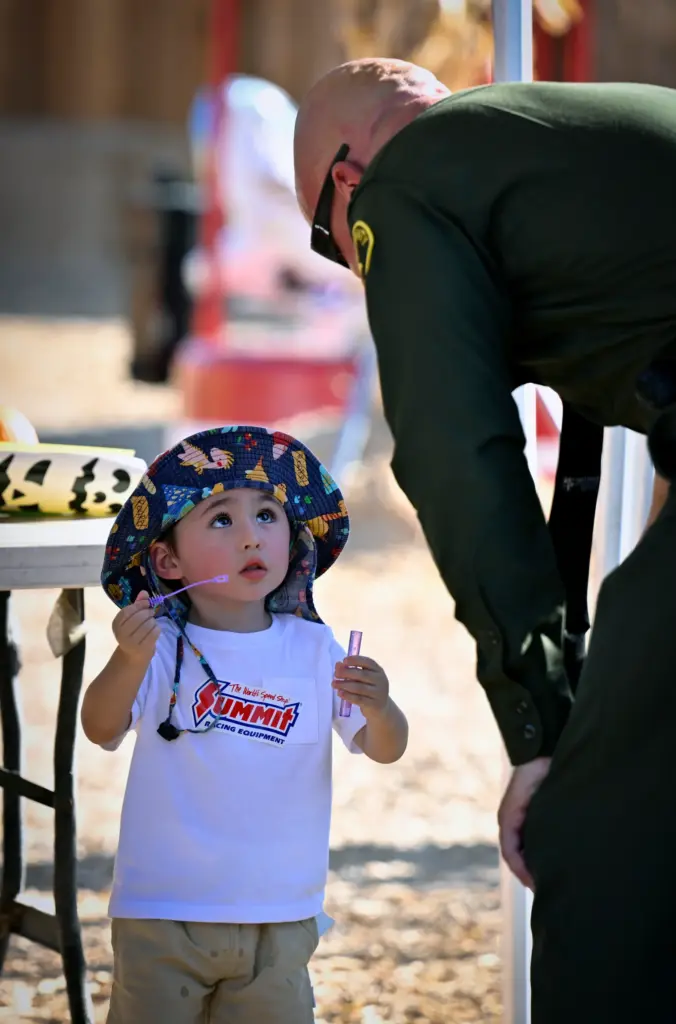 Frank Gatica, 3, left, talks with Orange County Sheriffâs Department...