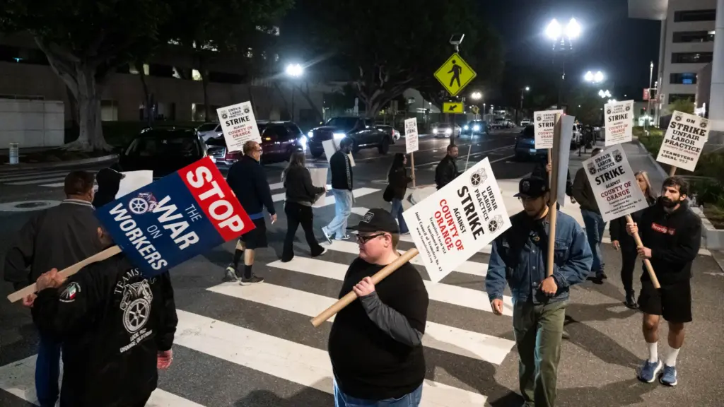 Members of Teamsters Local 952 picket in front the county...