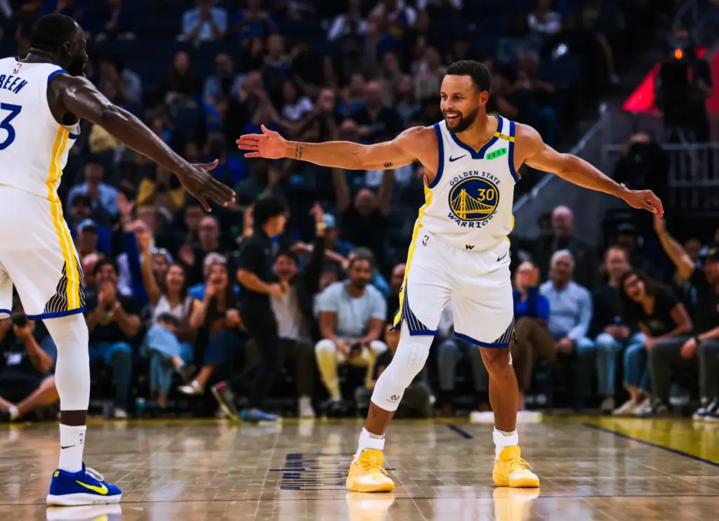 Golden State Warriors guard Steph Curry, right, celebrates with forward...