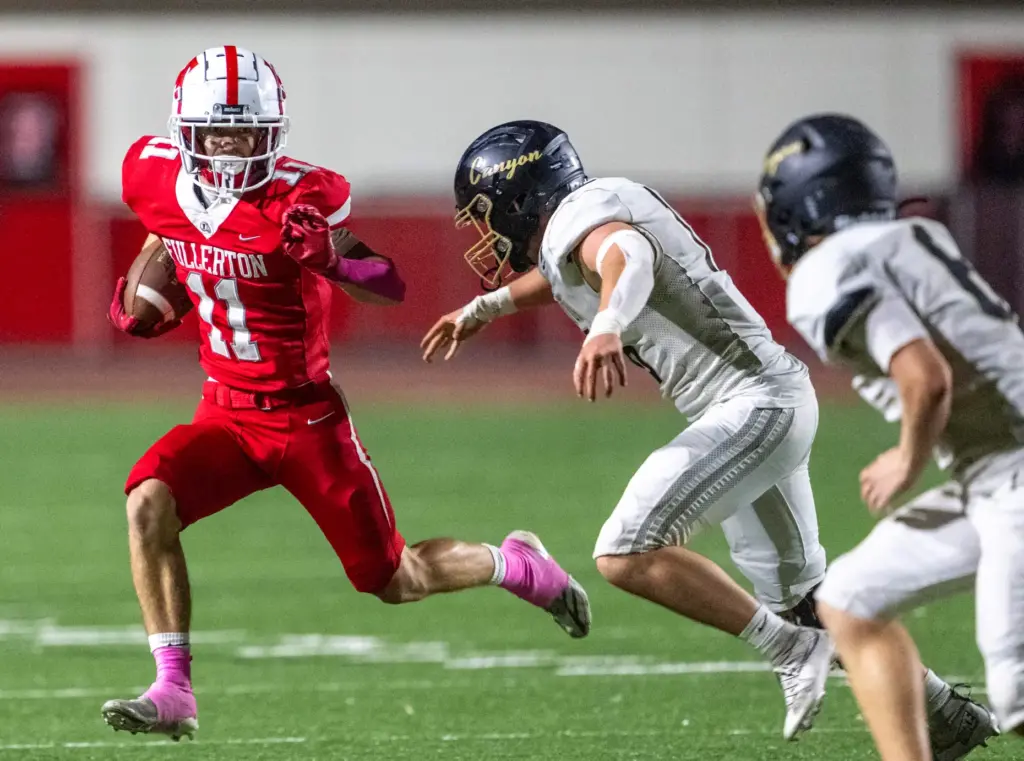 Fullerton running back Logan Moore (11) carries the ball during...