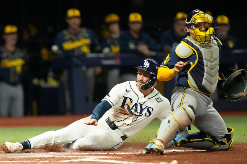 The Tampa Bay Rays’ Jonny DeLuca scores past Milwaukee Brewers...