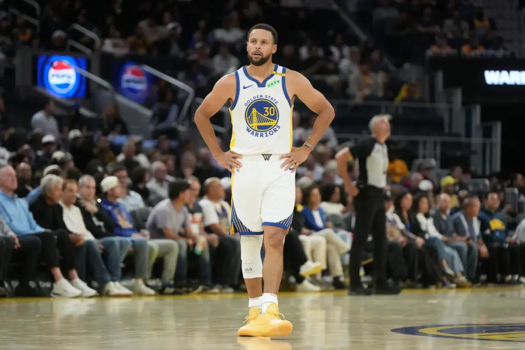 Golden State Warriors guard Steph Curry stands on the court...