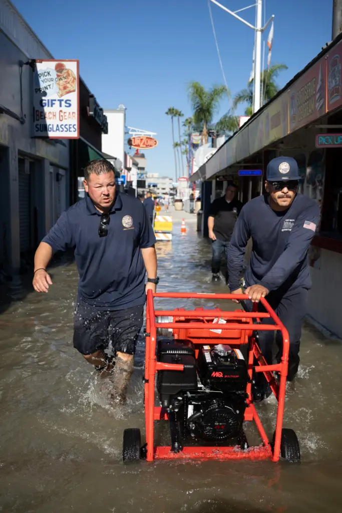 Workers with the Newport Beach Utilities Department bring in several...