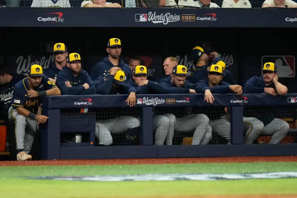 Members of the Milwaukee Brewers watch from the dugout during...