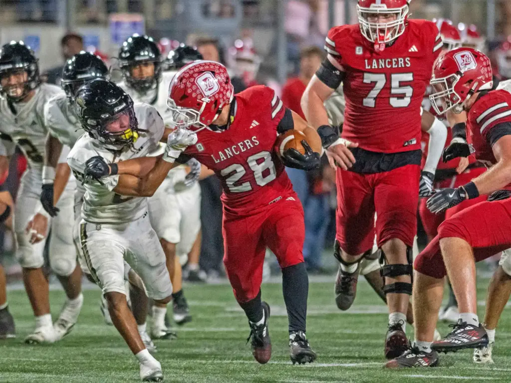 Serviteâs Kenneth Ashley Jr. (27) grabs the face mask of...