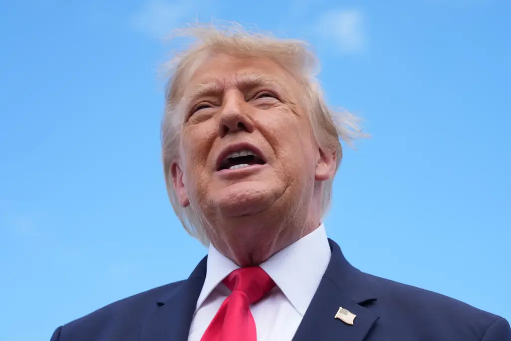 President Donald Trump speaks to reporters after arriving on Air...