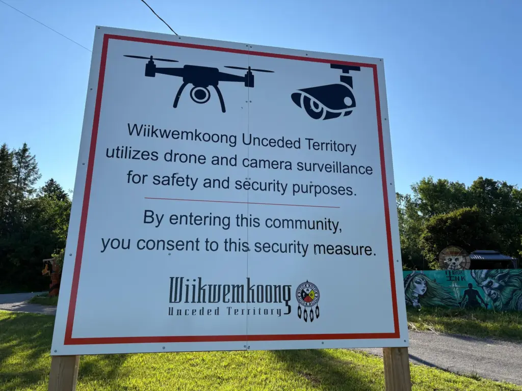 A sign warns visitors to the First Nations community of Wiikwemkoong that they could be monitored.