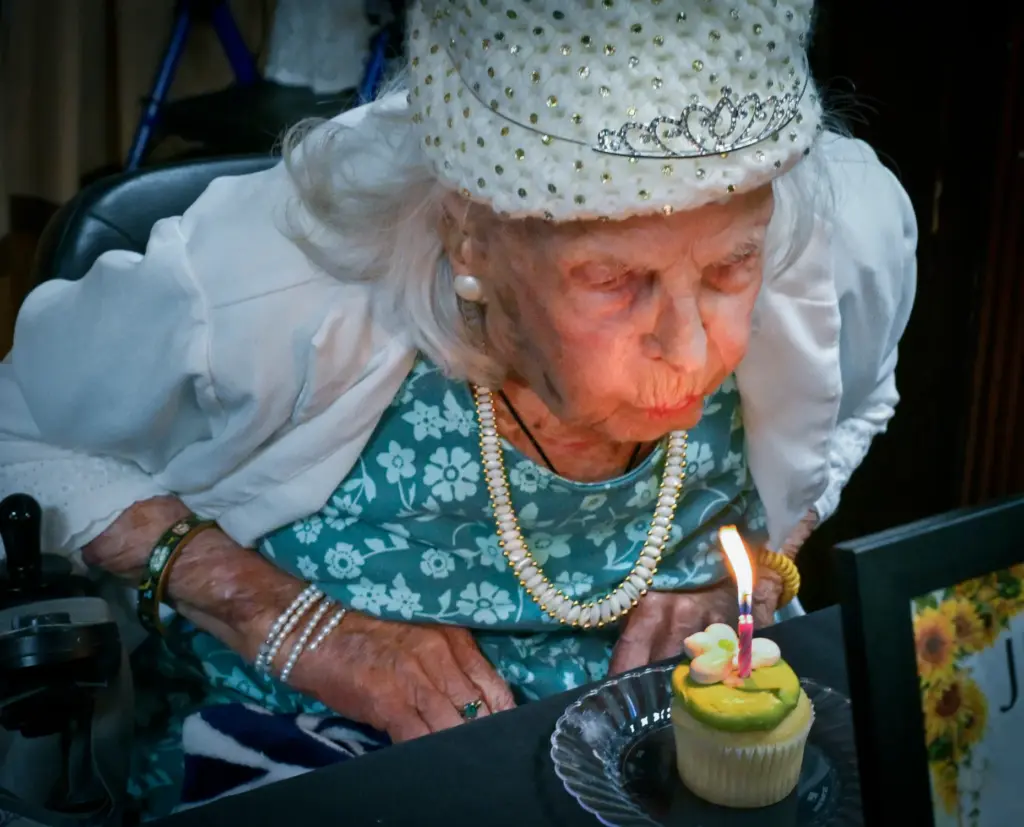 June Barthol attempts to blow out her candle after turning...