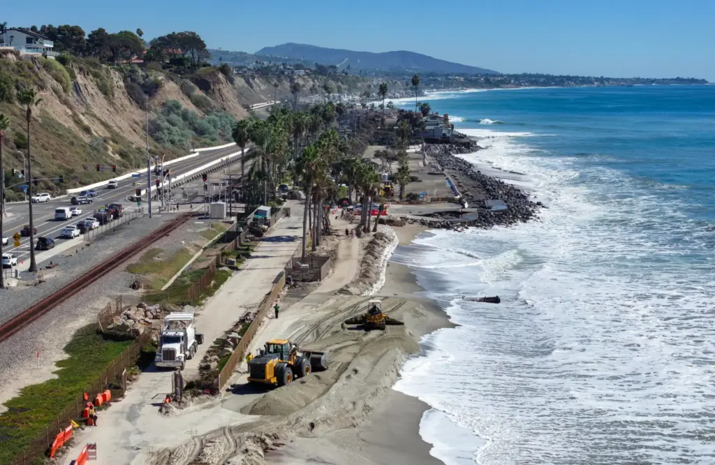 Truckloads of sand arrive at Capistrano Beach in Dana Point,...