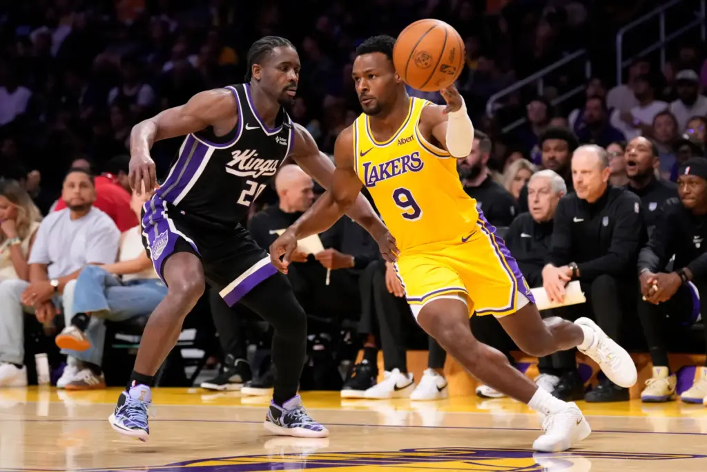 Lakers guard Bronny James, right, passes the ball while under...