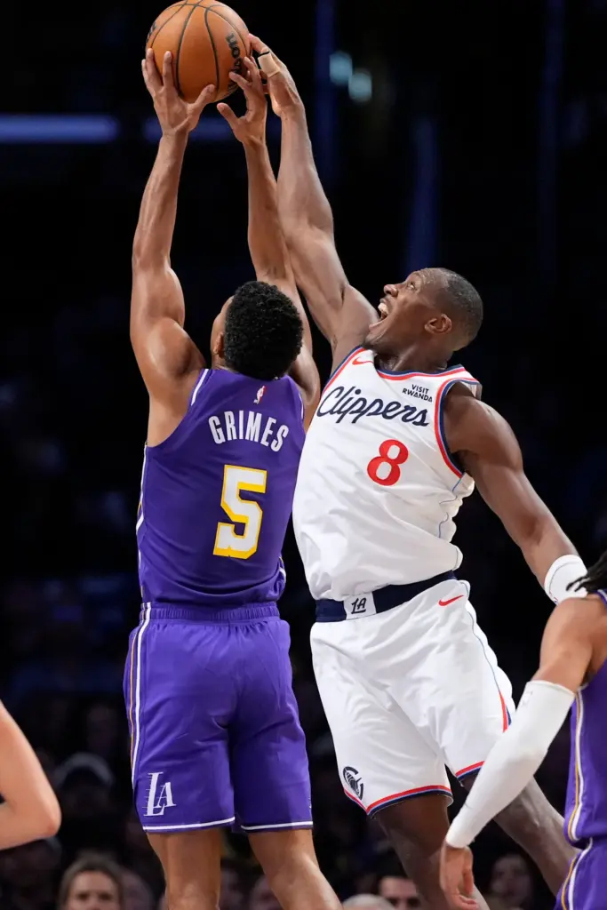 Lakers guard Quentin Grimes, left, and Clippers guard Kris Dunn...