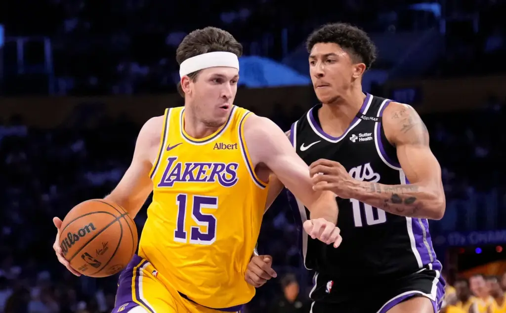 Lakers guard Austin Reaves, left, drives past Sacramento Kings guard...