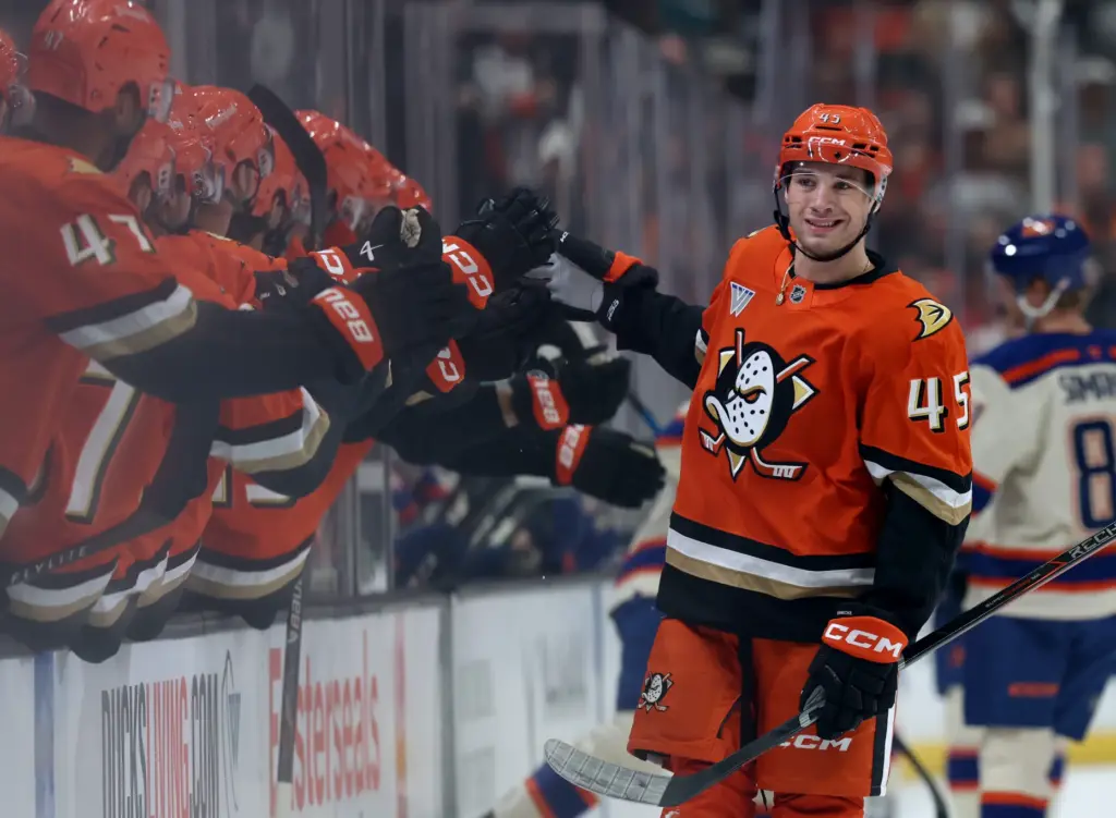 The Ducks’ Beckett Sennecke celebrates with teammates as he skates...