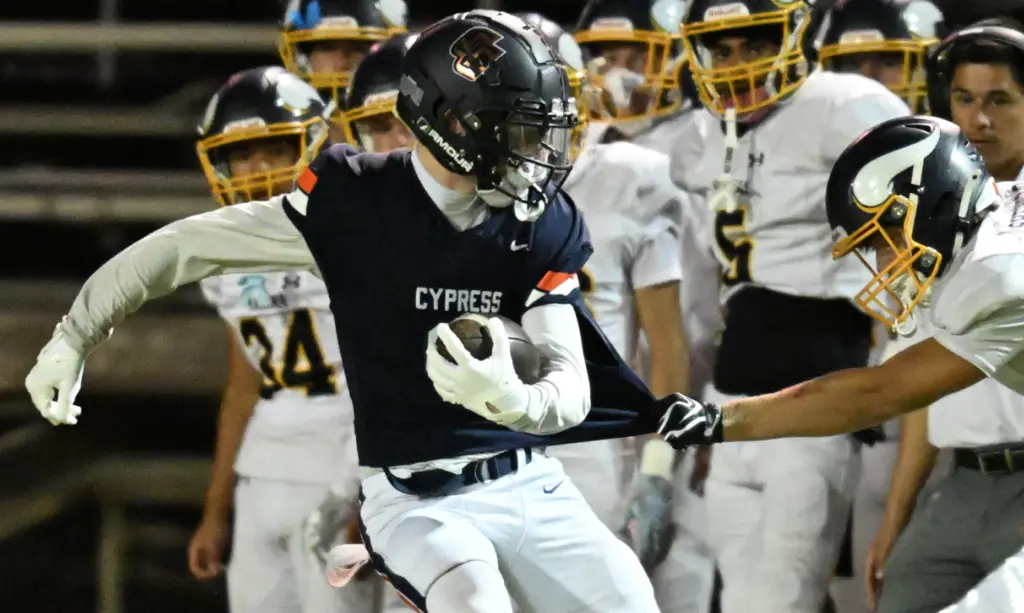 Caden Rynders #9 of Cypress is tackled in the first...