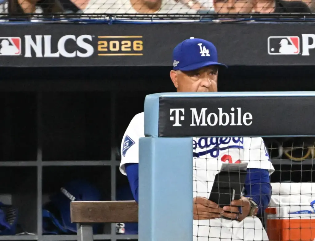Dodgers manager Dave Roberts watches from the dugout after the...