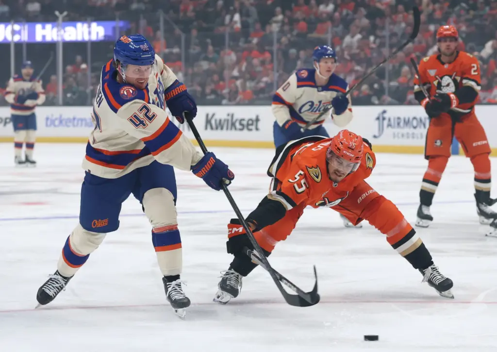 The Edmonton Oilers’ Kasperi Kapanen, left, takes a shot in...