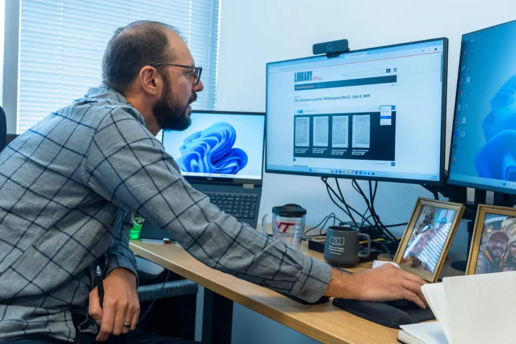 Smithsonian's Data Scientist Mike Trizna looks on a computer monitor at The Delaware Gazette.