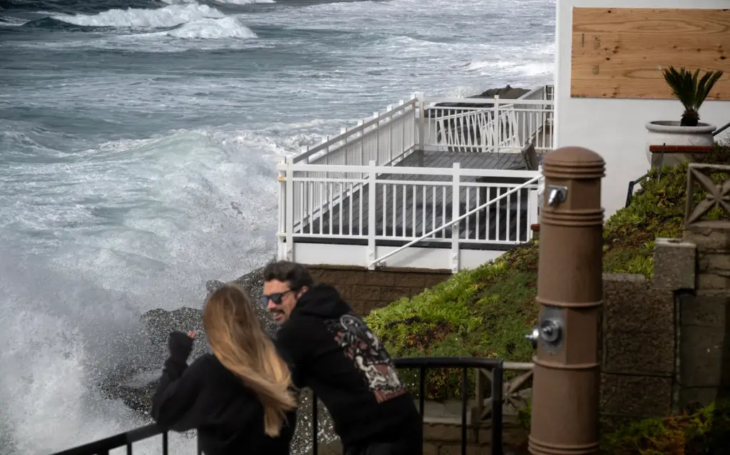 Waves crash into homes overlooking Brooks Street Beach in Laguna...
