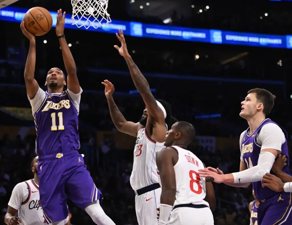 Lakers forward Ziaire Williams, left, shoots in front of Clippers...