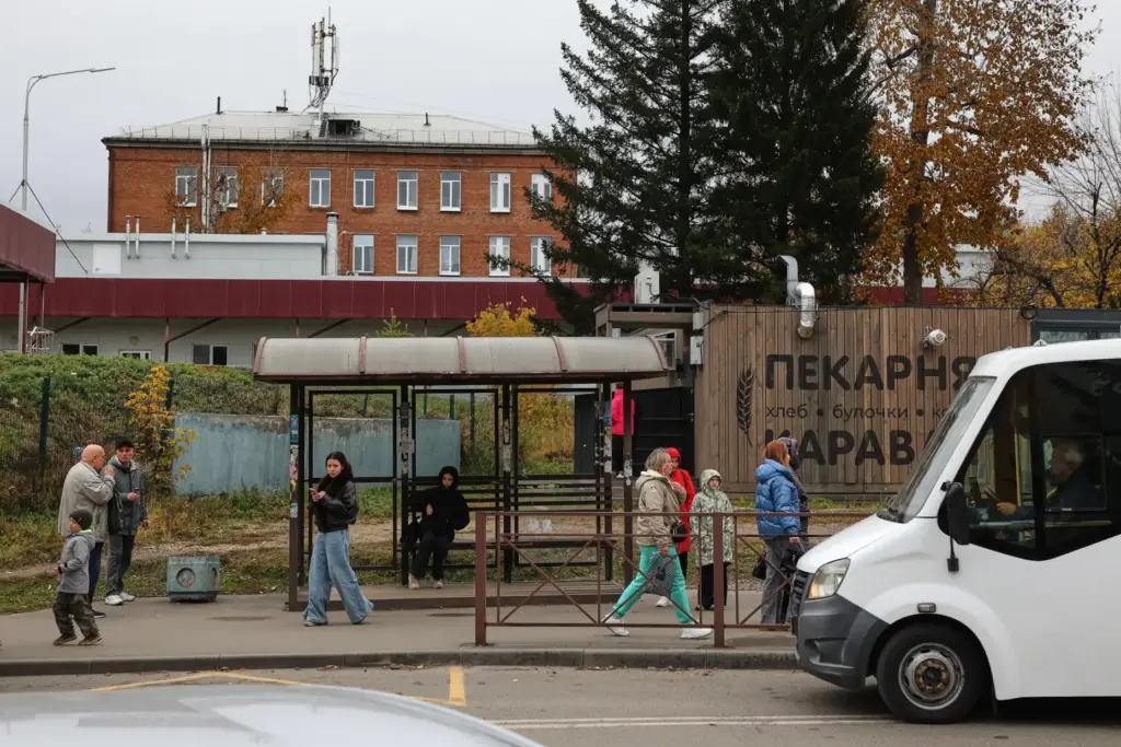 People are seen at a bus stop in Shelekhov, Russia.