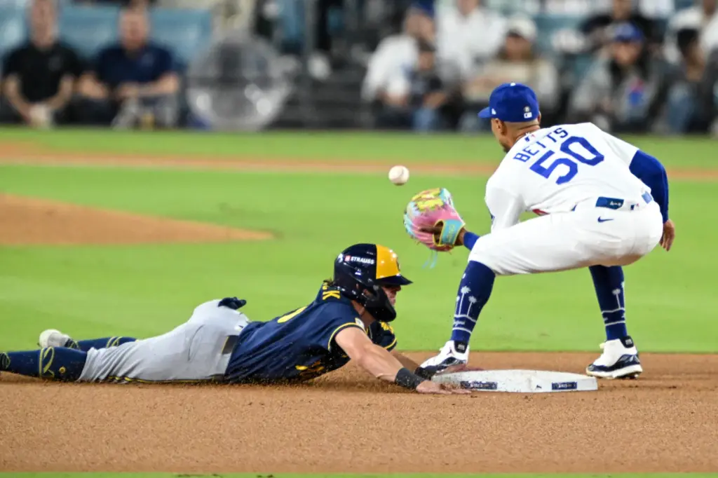 The Milwaukee Brewers’ Sal Frelick, left, steals second base as...