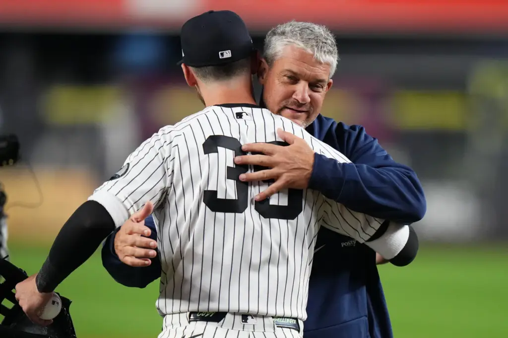 Former New York Yankees player Clay Bellinger, facing, greets his...