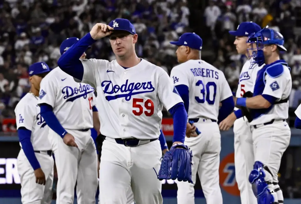 Dodgers relief pitcher Evan Phillips walks off the field after...