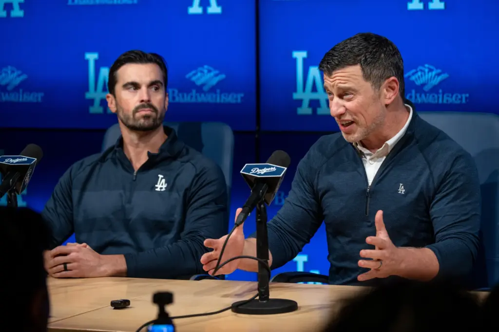 Dodgers president of baseball operations Andrew Friedman, right, speaks to...