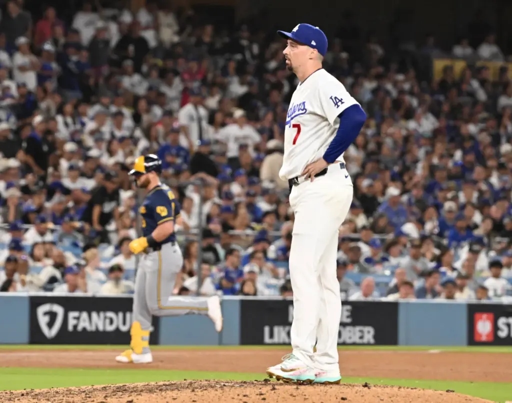 Dodgers starting pitcher Blake Snell looks on after giving up...