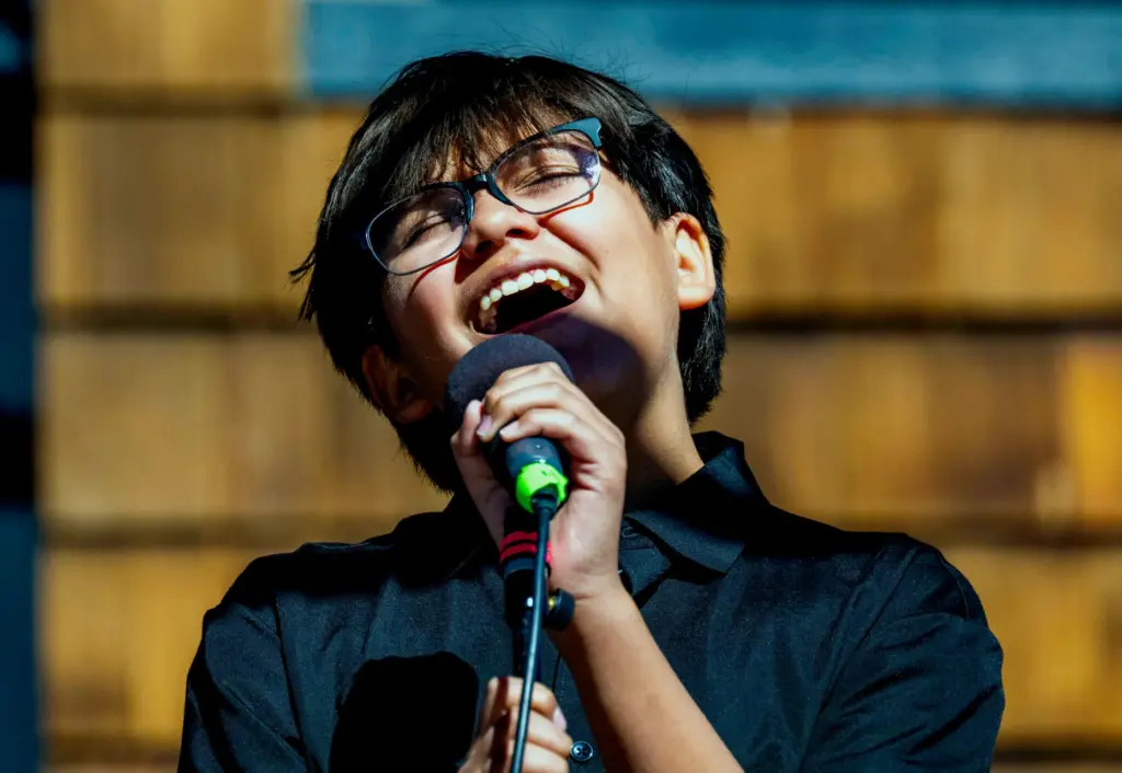 Urijah Rojas sings the national anthem during the celebration for...