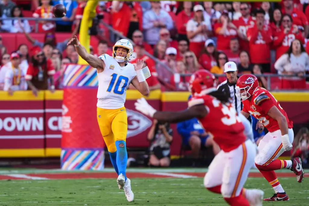 Chargers quarterback Justin Herbert (10) throws a pass under pressure...
