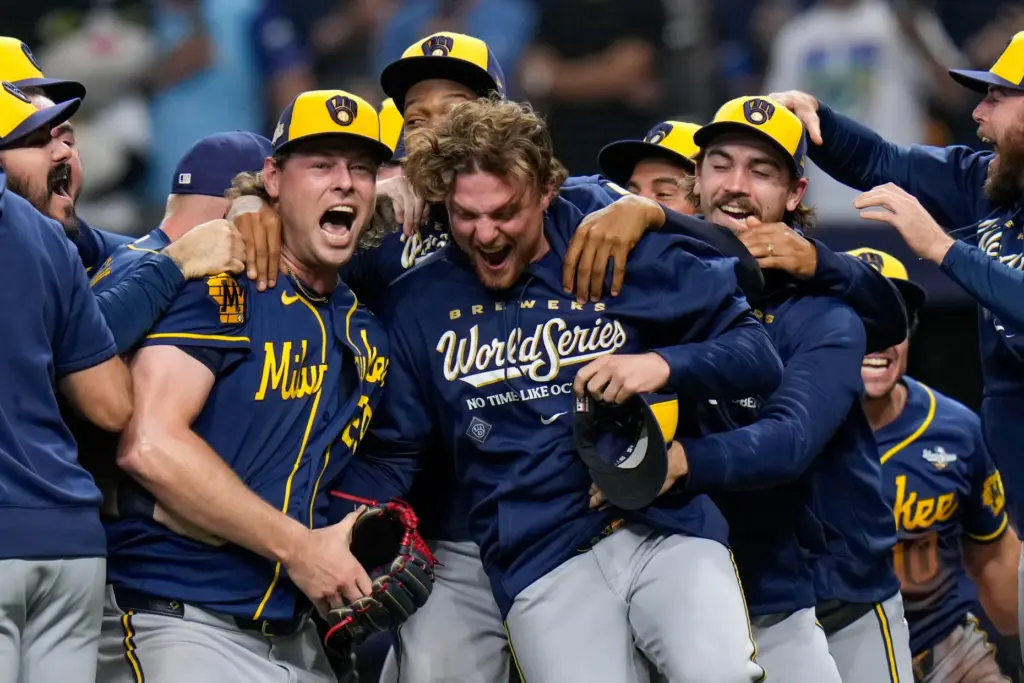 Milwaukee Brewers relief pitcher Trevor Megill, left, celebrates with teammates...