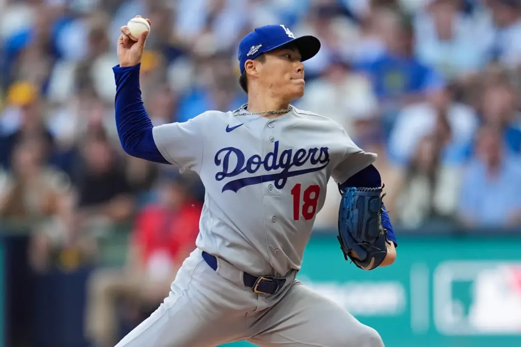 Dodgers starting pitcher Yoshinobu Yamamoto throws to the plate during...