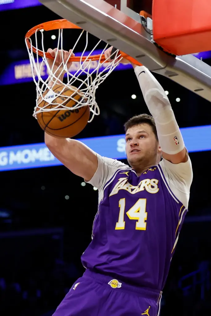 Lakers center Walker Kessler dunks during the second half of...