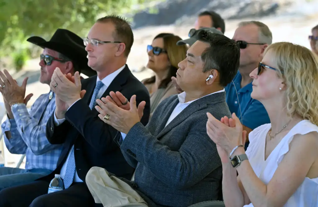 Guest speakers and community leaders applaud during the Rancho SoÃ±ado...