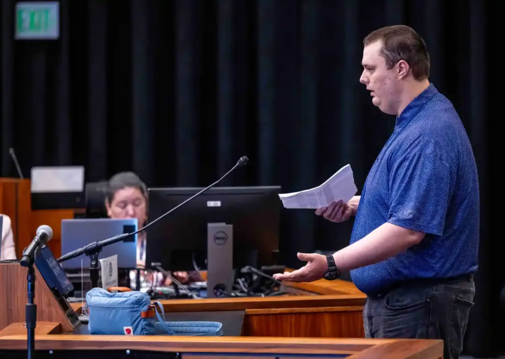 Noah Rhoades of Huntington Beach, a private security guard, urges...