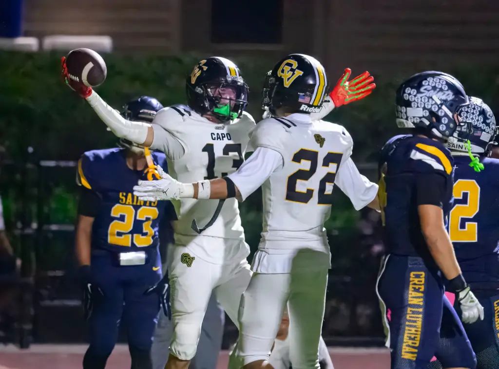Capistrano Valley wide receiver Cartyr Quartucy, left, celebrates scoring a...