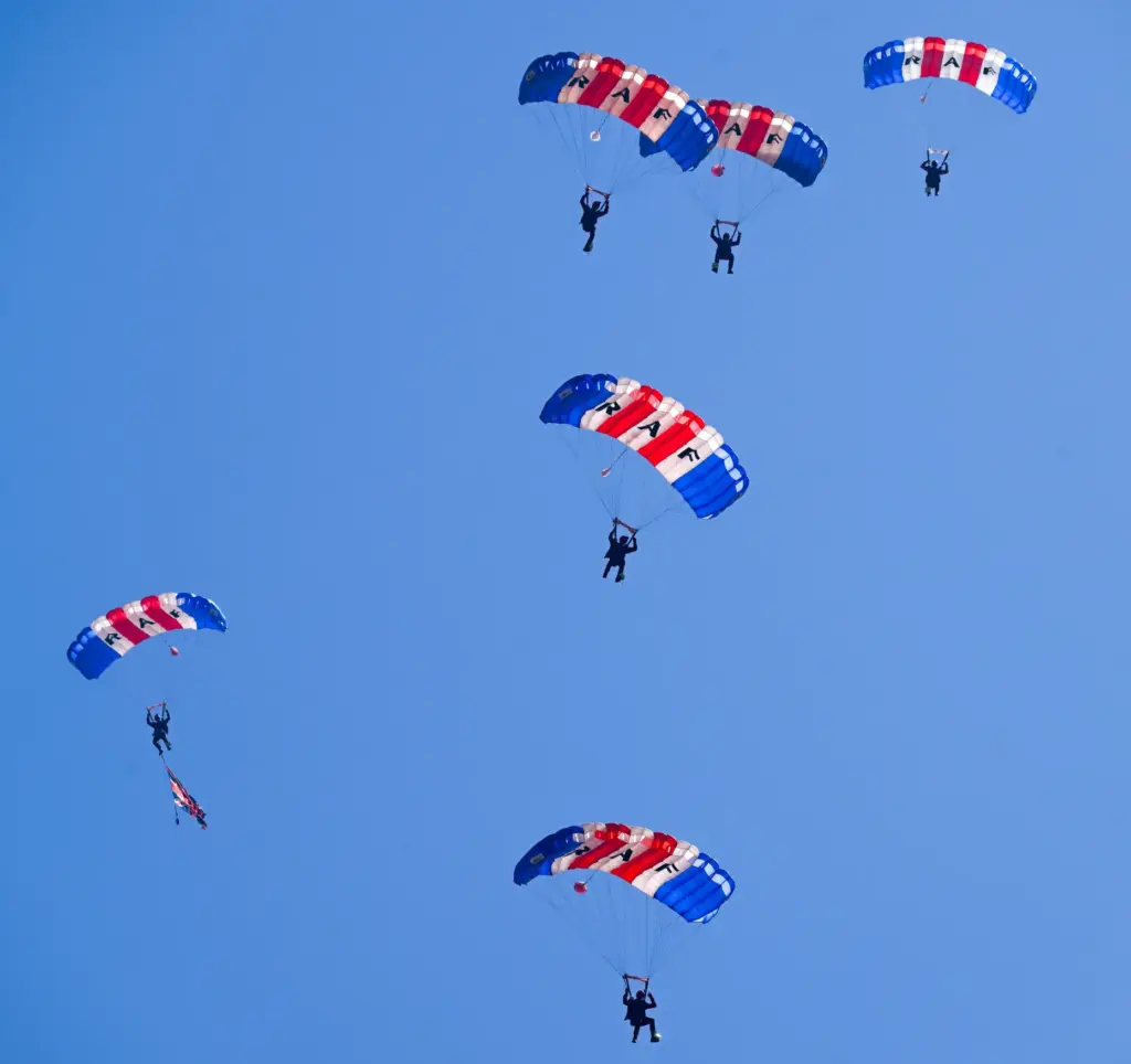 The Royal Air Force Falcons parachute team jump over the...