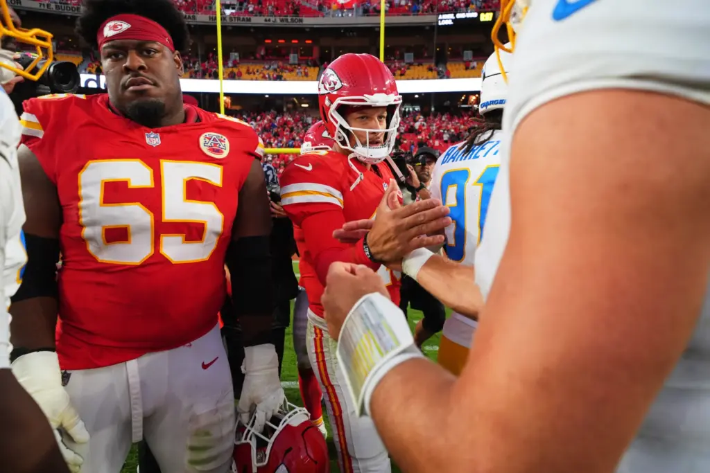 Kansas City Chiefs’ Trey Smith (65), Patrick Mahomes, center, and...