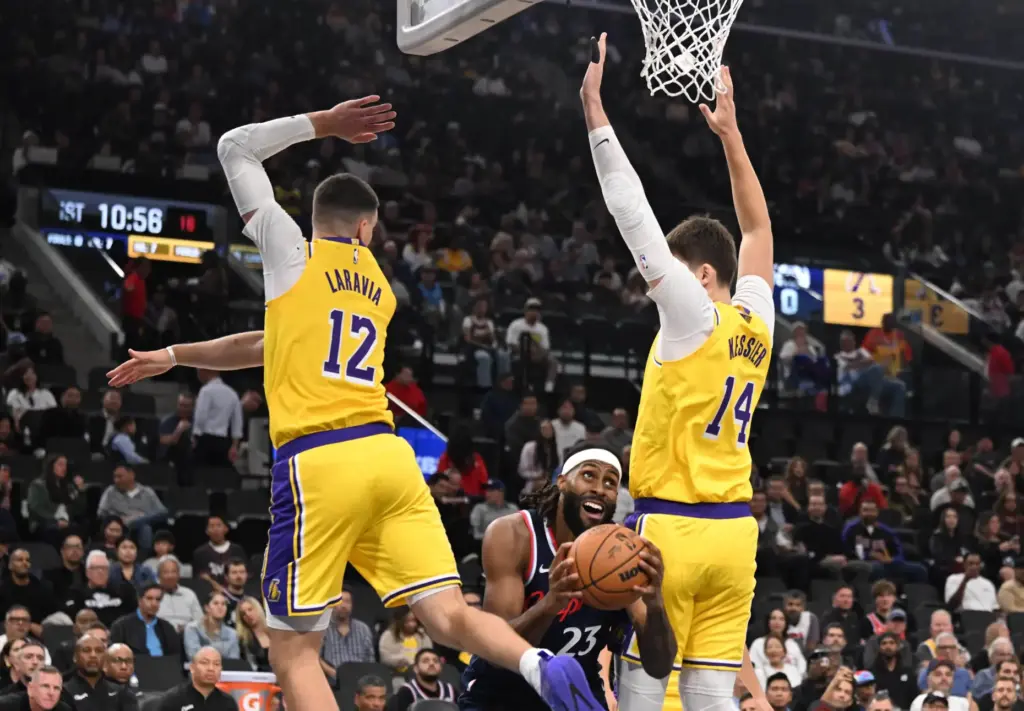 Clippers forward/center Isaiah Jackson drives to the basket between Lakers...