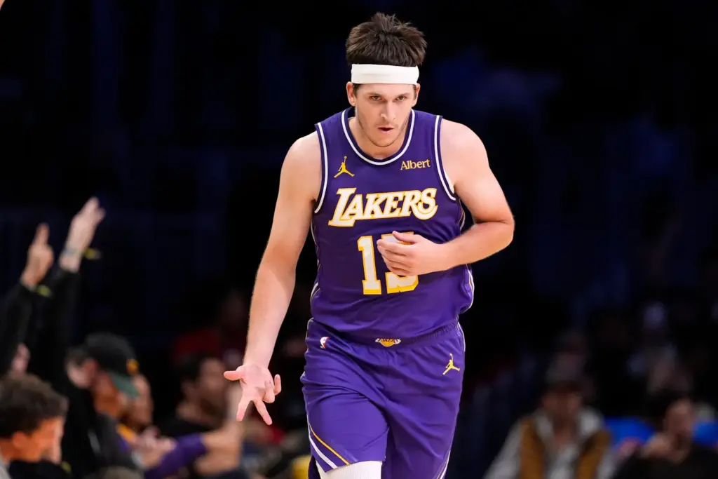 Lakers guard Austin Reaves gestures after scoring during the second...