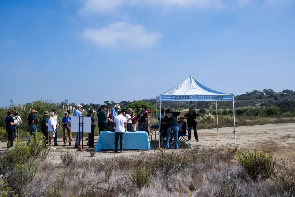 People listen to an update at the 387-acre Randall Preserve...