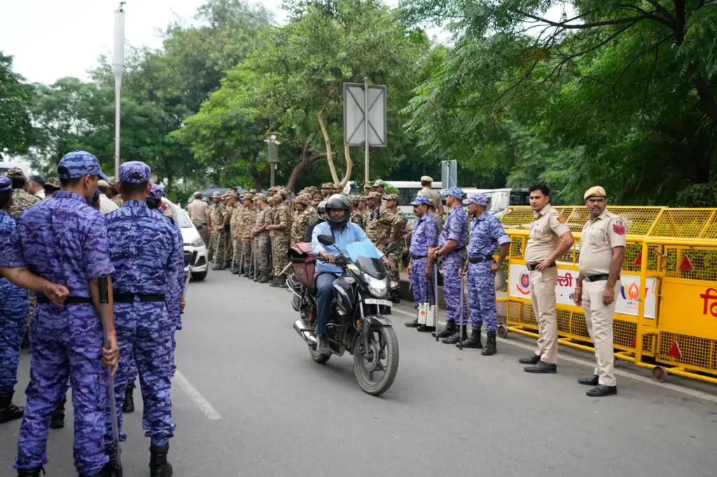 Security personnel assemble ahead of a tricolor (Indian flag) waving...