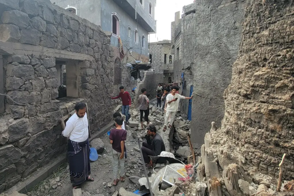 Residents inspect debris of their homes after a missile strike in Seina, Taiz, Yemen.