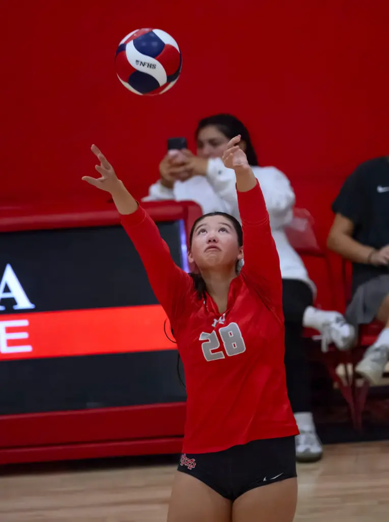 Mater Dei’s Riley Stringer sets the ball for a teammate...