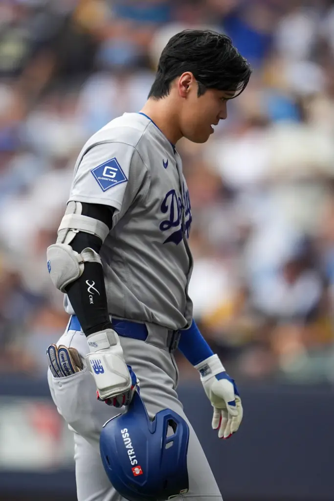 Dodgers star Shohei Ohtani returns to the dugout after grounding...
