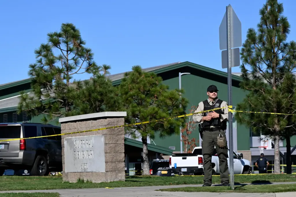 Police tape is placed outside Silver Rail Elementary school, where...